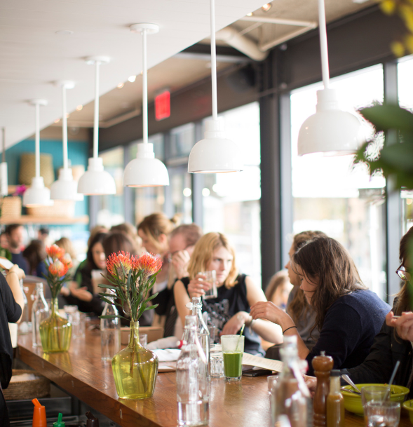 Cafe Gratitude location interior bustling with customers