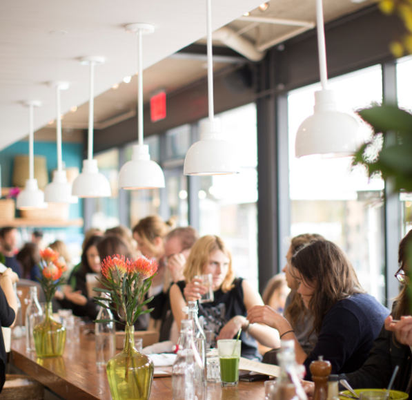 Cafe Gratitude location interior bustling with customers